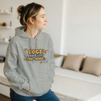 Load image into Gallery viewer, Ash - Dogs Make Life Paw-some hoodie, worn by a woman sitting on a couch in a living room
