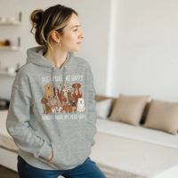 Load image into Gallery viewer, Ash - Dogs Make Me Happy hoodie, worn by a woman sitting on a couch in a living room
