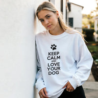 Load image into Gallery viewer, White - Keep Calm and Love Your Dog sweatshirt, worn by a woman leaning on a white wall
