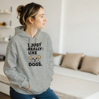 Load image into Gallery viewer, Ash - I Just Really Like Dogs hoodie, worn by a woman sitting on a couch in a living room
