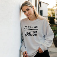 Load image into Gallery viewer, Sport Grey - It Was Me I Let The Dogs Out sweatshirt, worn by a woman leaning on a white wall
