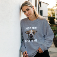 Load image into Gallery viewer, Graphite Heather - I Got That Dog In Me sweatshirt, worn by a woman leaning on a white wall
