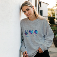 Load image into Gallery viewer, Ash - Peace Love Dogs sweatshirt, worn by a woman leaning on a white wall

