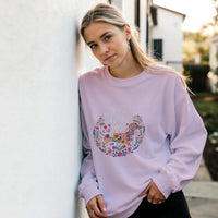 Load image into Gallery viewer, Light Pink - Just A Girl Who Loves Dogs sweatshirt, worn by a woman leaning on a white wall
